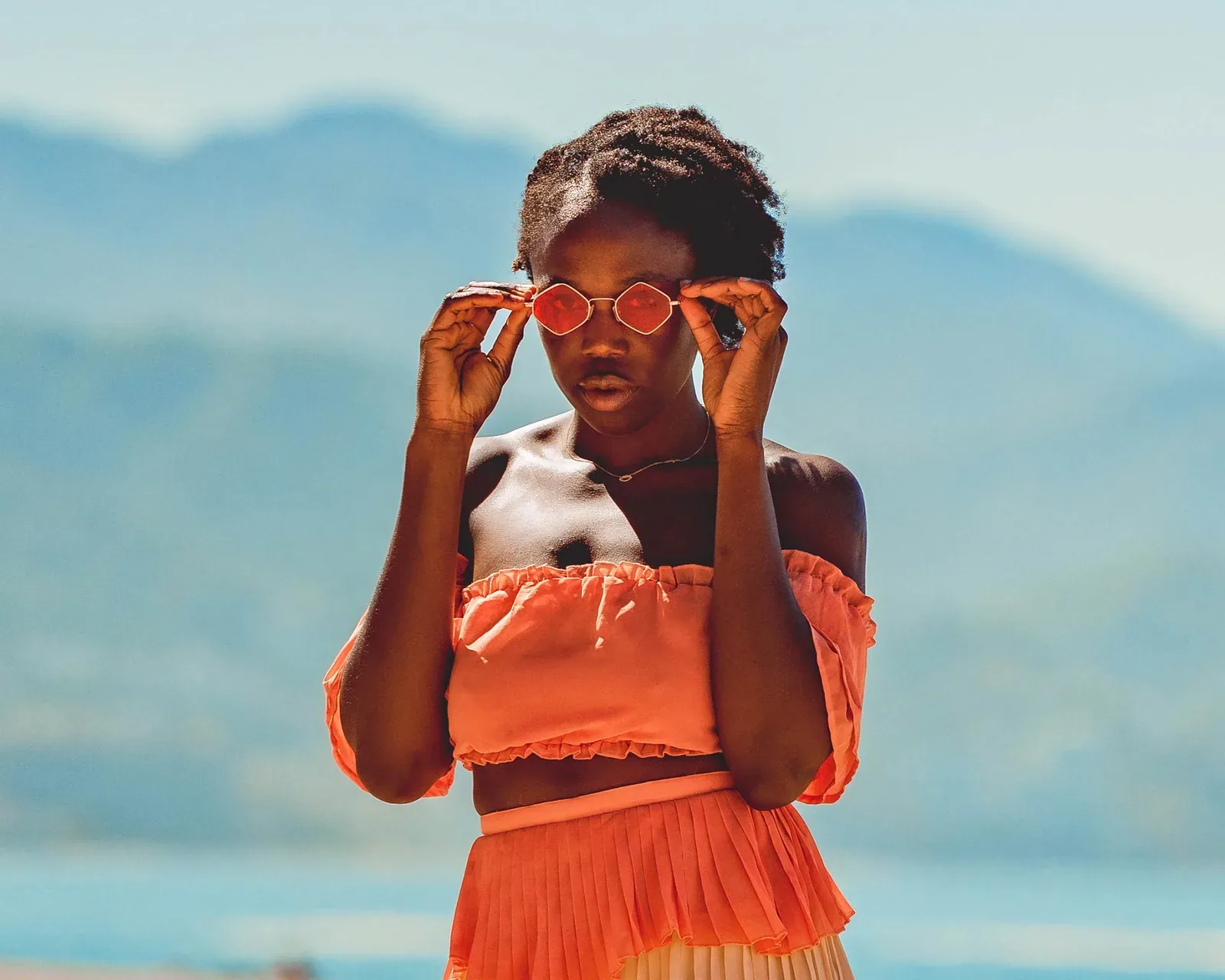 Editorial de moda, vestido naranja y lentes de sol