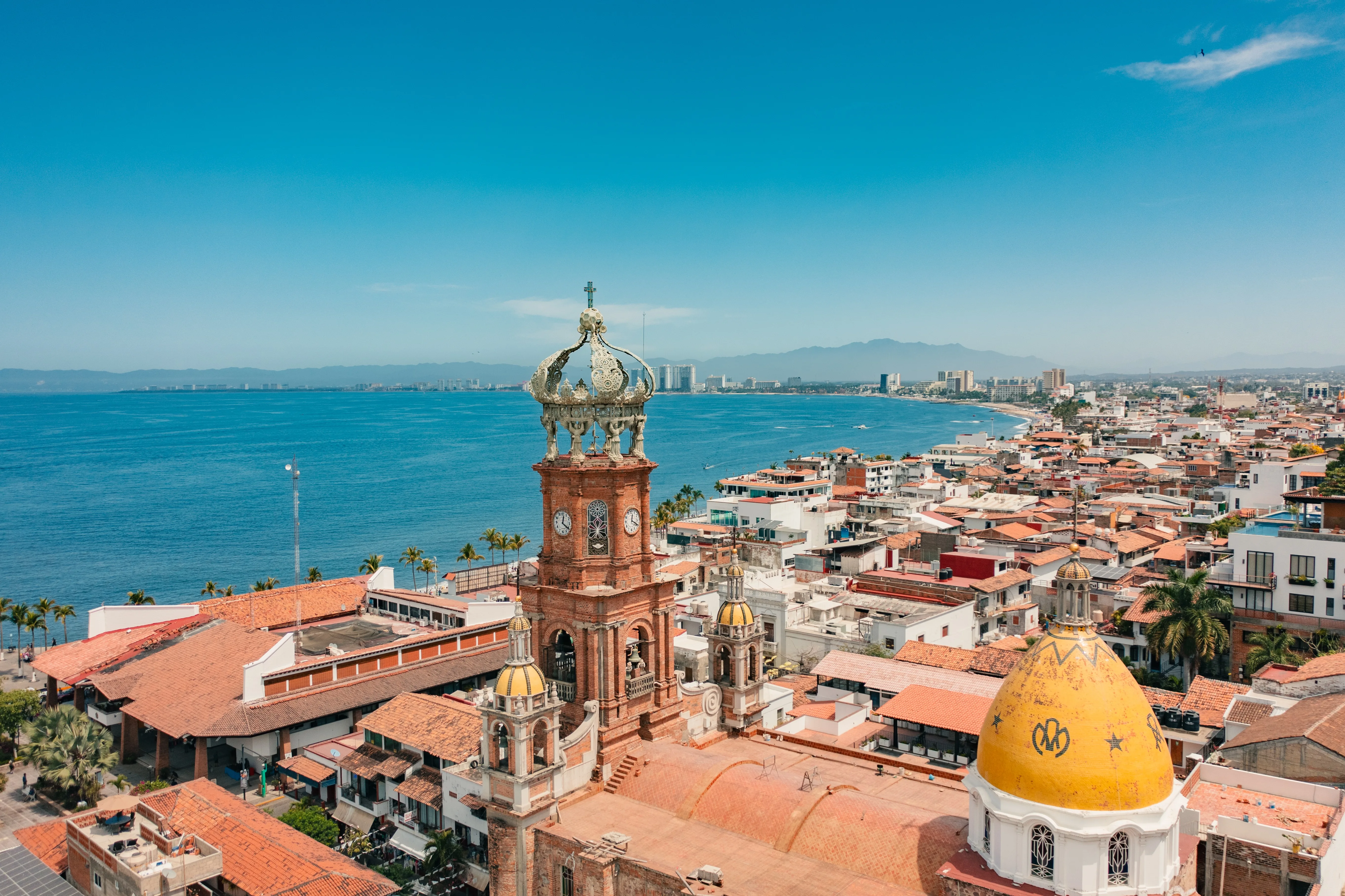 Aerial of Old Town Puerto Vallarta and the crown of Our Lady of Guadalupe church above Banderas Bay