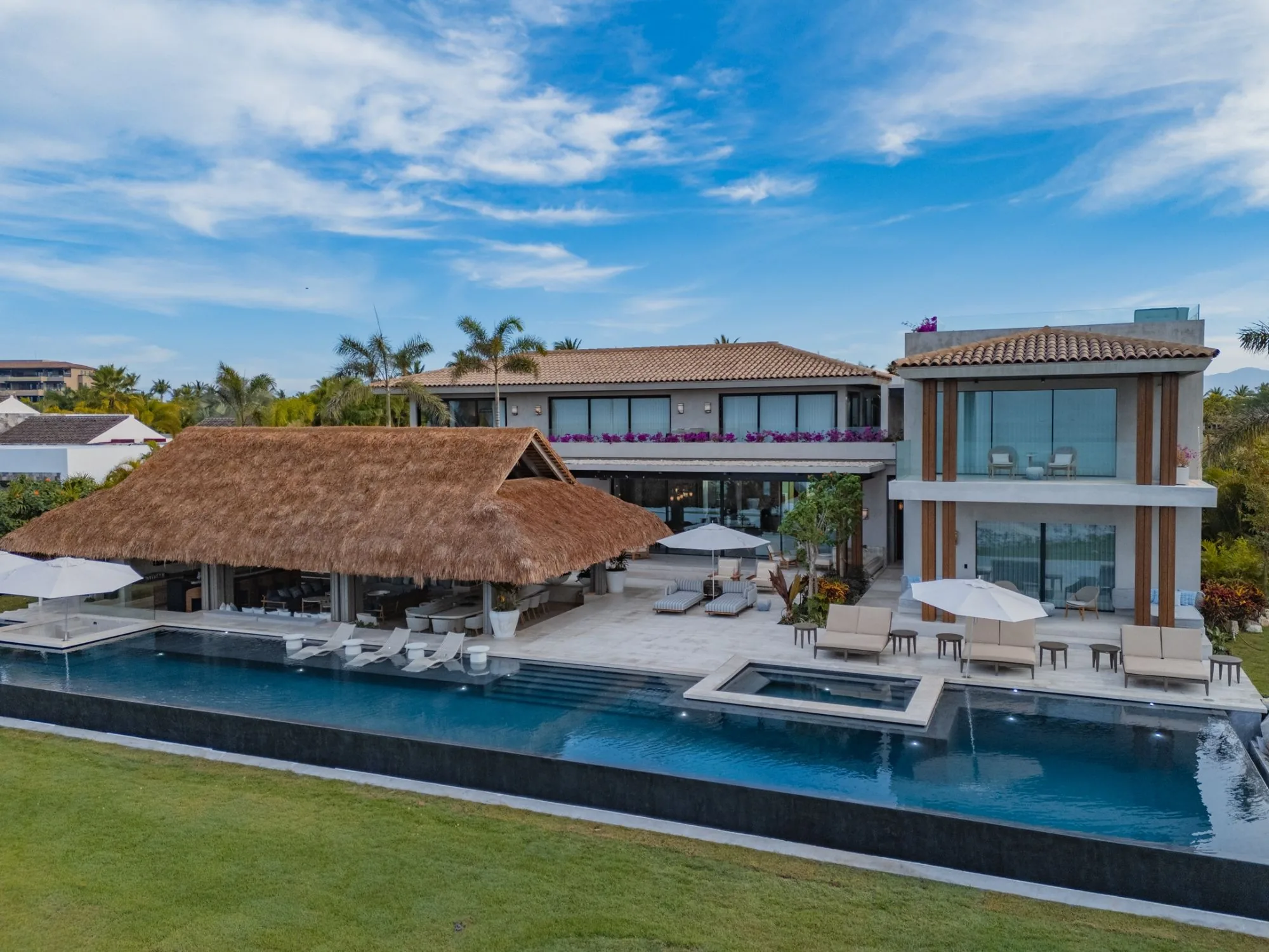 Oceanfront villa with a palapa and infinity pool, aerial view